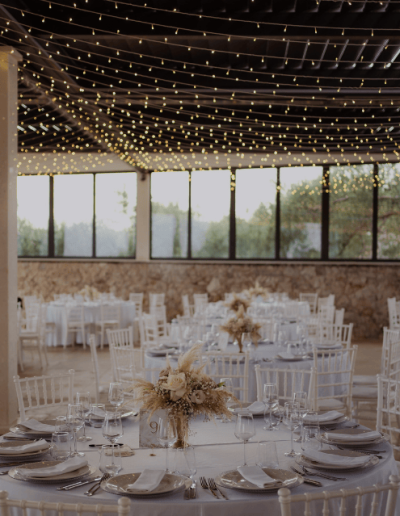 Elegant wedding reception setup in Croatia with round tables, white decor, floral arrangements and string lights on the Adriatic coast.