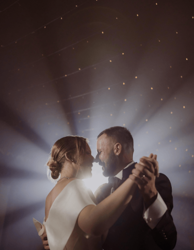 Bride and groom sharing a romantic first dance under soft lights during their wedding in Croatia.