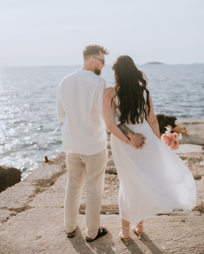 Couple walking by the Adriatic Sea during an intimate destination wedding in Croatia on the Dalmatian coast